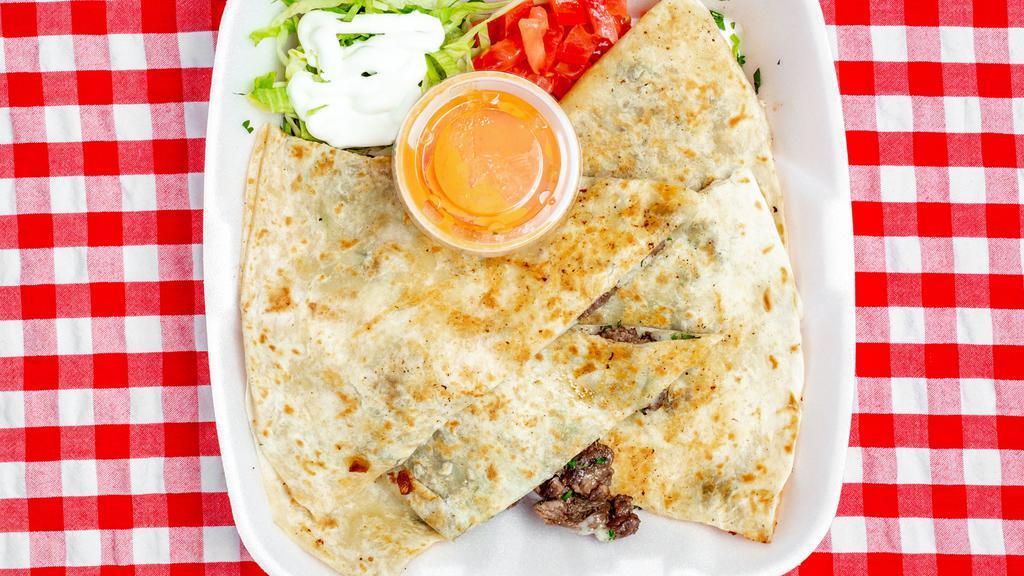 Quesadillas · Large tortilla filled with your choice of meat. Served with side of lettuce tomato and sour cream