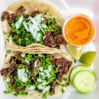 Tacos · Your choice of meat topped with cilantro and onions.