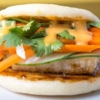 Pork Belly Bao · Streamed-cloud-like bread bun filled with braised pork belly, pickled daikon carrots and cuc...