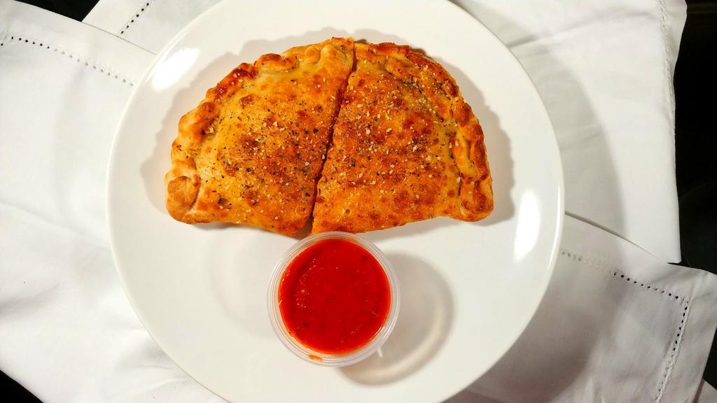 Calzone · Loaded with cheese and two of your favorite pizza toppings, served with a side of our marinara sauce.