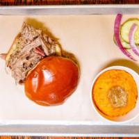 Pulled Pork Sandwich · Slow-smoked juicy pulled pork on a toasted buttery bun.