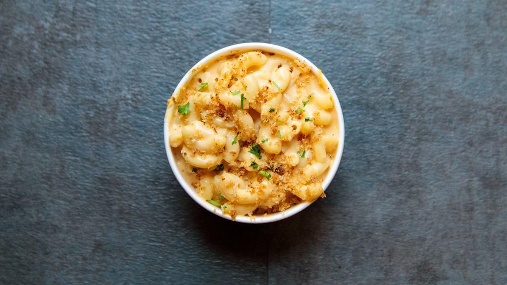 Mac & Cheese · Macaroni noodles in our made from scratch creamy cheddar sauce, topped with garlic crumbles.