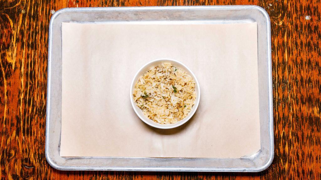 Bbq Rice · Long grain rice cooked in our smoked chick'n broth and sprinkled with fresh parsley.