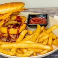 Cowboy Burger · Fresh handmade 1/3 lb. patty, bacon strips, onion rings, Cheddar Crisp and BBQ sauce on a to...