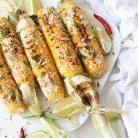 Elotes · Corn, mayo, Cotija cheese, chili powder and lime.