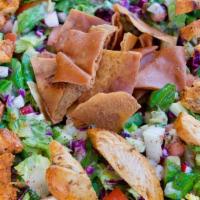 Chicken Fattoush Salad · Chopped romaine lettuce, tomatoes, cucumbers, purple cabbage, and radishes tossed in our hou...