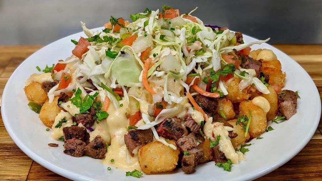 Totchos Grande · Like nachos, but with a midwestern twist: Tater tots topped with queso, pico de gallo, slaw, and your choice of grilled chicken or marinated bison flank.