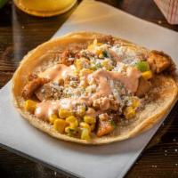 Street Corn Chicken Taco - Single · Ancho-rubbed chicken, roasted corn, Cotija cheese, drizzled in a chile-lime salsa on corn to...