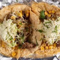 Cowboy Taco - Single · Lime-grilled steak, caramelized onion, roasted corn, Chihuahua cheese, with a dollop of home...
