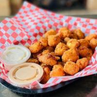 Cheese Curds · Wisconsin cheese curbs battered and fried, served with a side of ranch dressing.