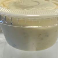 Bleu Cheese Dressing · One side of blue cheese dressing.