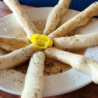 Breadsticks · 8 Breadsticks Glazed with Garlic Butter.  Served with Beer Cheese Queso.