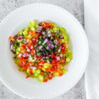 Salad Shirazi (Persian Salad) · Diced tomato, cucumber, onion and parsley dressed with olive oil and lemon juice.