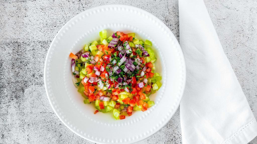Salad Shirazi (Persian Salad) · Diced tomato, cucumber, onion and parsley dressed with olive oil and lemon juice.