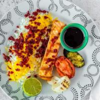Grilled Salmon With Jeweled Rice · Salmon, grilled and topped with our homemade pomegranate sauce. Served along side grilled ve...