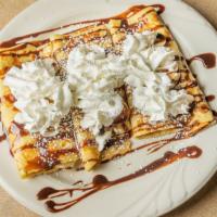 Banana Nutella Crepes · Three crepes filled with nutella and banana and topped with whipped cream.