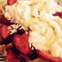 Tutti Frutti Crepes · Three crepes filled with fresh strawberry and banana and topped with whipped cream.
