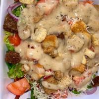 Caesar Salad · Romaine lettuce, cucumbers, red onions, croutons, grated Parmesan cheese, and Caesar dressing.