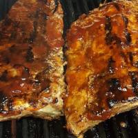 1/2 Slab Bbq Baby Back Ribs · Served with bread and choice of two sides.