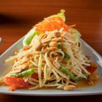 Papaya Salad · Hot and spicy. Traditional Thai salad with papaya, tomato, peanuts, green beans, and chilis.