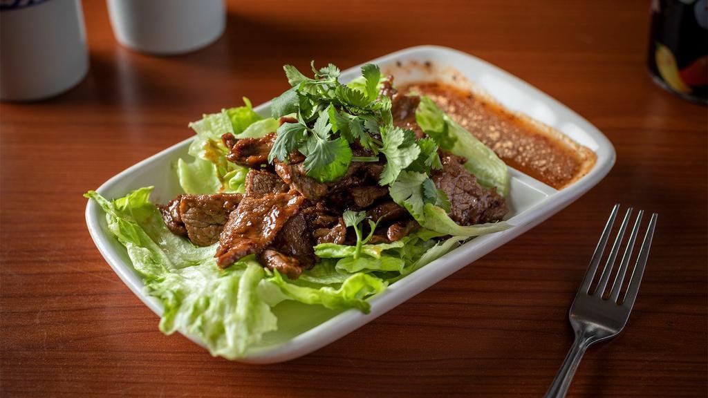 Crying Tiger Salad · Hot and spicy. Grilled marinated beef served with spicy sauce.