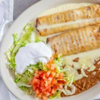 Chimichanga · Two fried burritos of your choice of shredded chicken, ground beef or shredded beef with bea...
