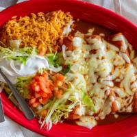 Enchiladas Rancheras · One chicken, one beef, one cheese, topped with lettuce, tomato, sour cream, and your choice ...