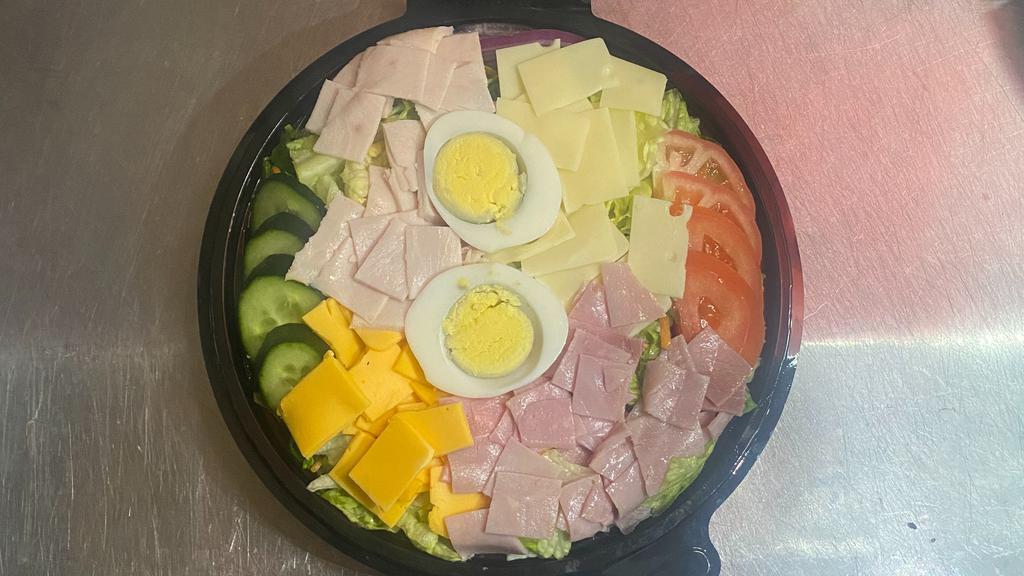 Antipasto · Mixed greens, tomatoes, onions, croutons topped with ham, salami, provolone cheese, pepperoncini peppers, cucumber, and black olives.