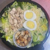 Caesar Salad · Fresh romaine lettuce, shredded Parmesan, croutons topped with hard boiled egg.