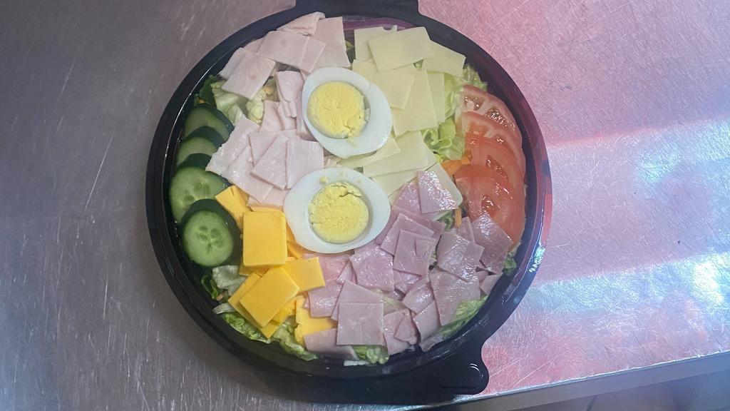 Chef · Mixed greens, tomatoes, onions, cucumber, ham, turkey, American, and Swiss cheese. Topped with a hard-boiled egg.