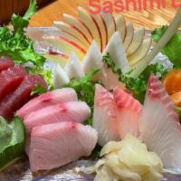 Sashimi Deluxe · Chef's choice (15) pieces of sashimi and a bowl of rice. Served with house salad or miso soup.