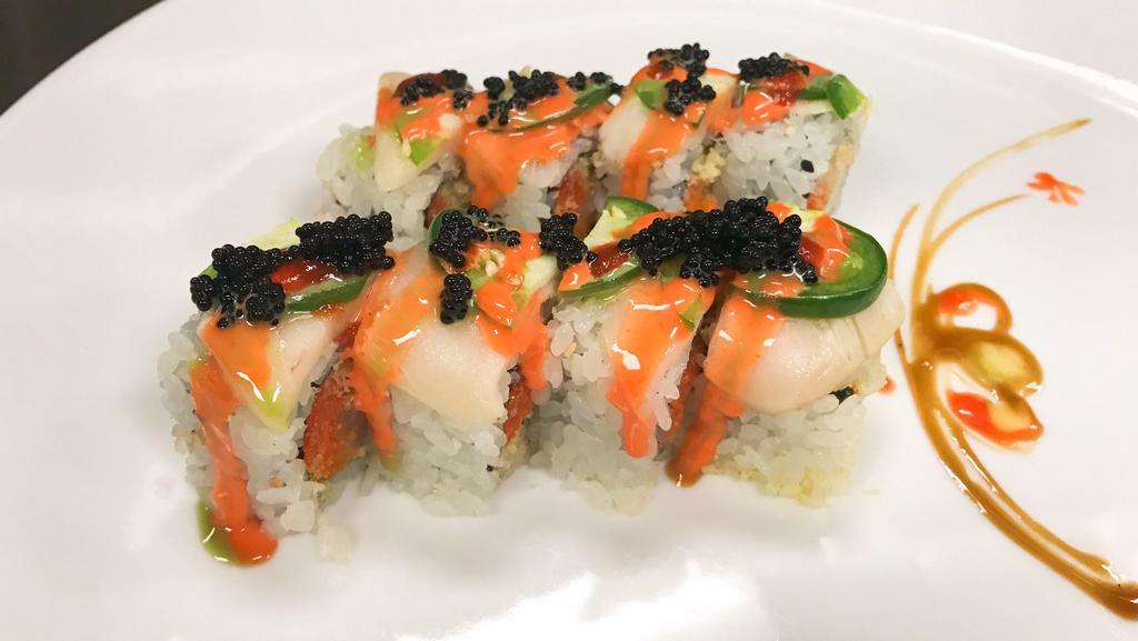 Kiss Of Fire Roll · Spicy yellowtail and avocado inside. Topped with white tuna and yellowtail. Served with spicy mayo, wasabi, chili sauce, and black tobiko.