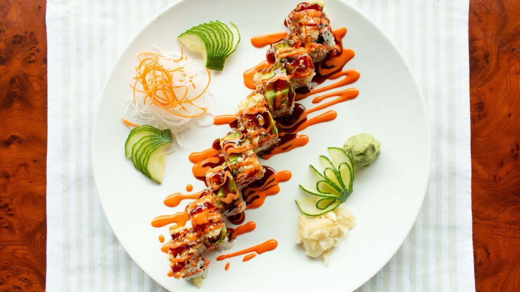 Western Roll · Spicy crab with crunch and avocado inside. Topped with avocado, shrimp tempura, spicy mayo, and eel sauce.