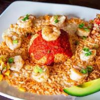 Arroz Con Camaron · A bed of rice topped with seasoned shrimp covered with queso sauce. Garnished with mango sal...