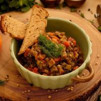 Eggplant Ikra Spread · Stewed eggplant caviar spread mixed with
chopped carrot, bell pepper, garlic, onions,
served...