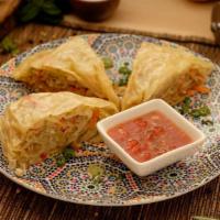 Oromo · Traditional steamed pie with minced vegetables in a long thin wrap.