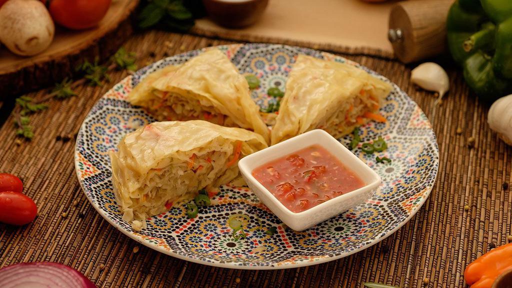Oromo · Traditional steamed pie with minced vegetables in a long thin wrap.