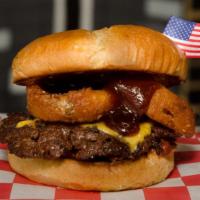 Rodeo Burger · Butter seared beef, melted American cheese, beer-battered onion rings, crispy bacon, and swe...