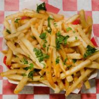 Garlic Fries · Hot and crispy fries tossed in signature garlic sauce and parsley garnish.