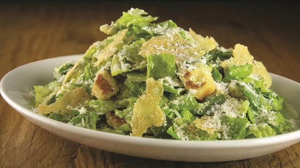 Caesar · Romaine lettuce, croutons, parmesan crisps, and creamy anchovy dressing.