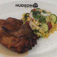 Gerber Farms Chicken · Half roasted chicken, roasted corn and avocado, and natural jus.