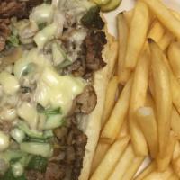 Philly Steak & Cheese (6Oz.) · With grilled mushrooms, green peppers, and onions. Served on a Grecian roll.