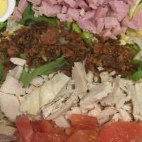 Cobb Salad · Chicken, avocado, egg, tomato, bacon, onion, and bleu cheese.