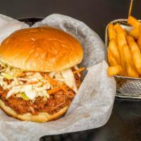 Pulled Pork Sandwich · Pulled pork smothered in BBQ sauce with Aunt Mary's slaw served on a buttery bun.