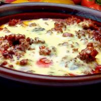 Queso Fundido · Chorizo (Mexican sausage) served with cheese dip and flour or corn tortillas .