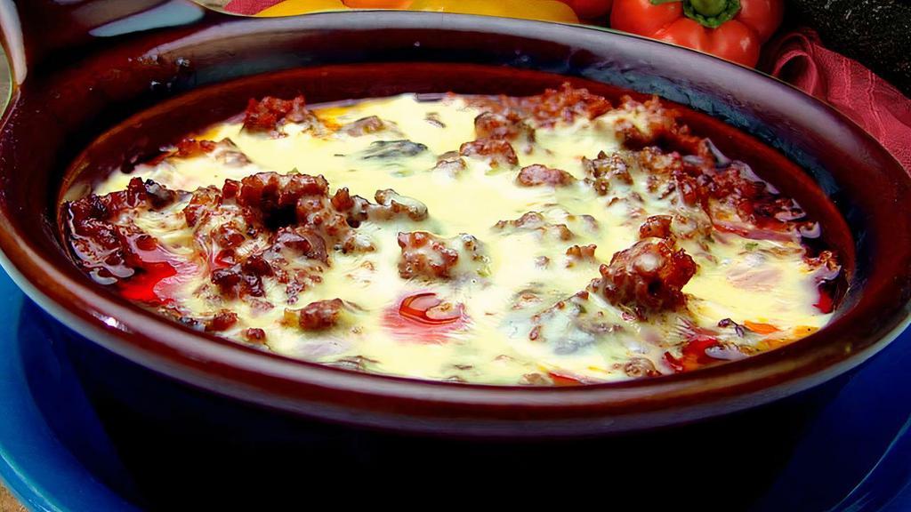 Queso Fundido · Chorizo Mexican sausage served with cheese dip and three warm tortillas.