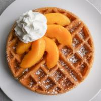 Peach Waffle · A golden Belgian waffle topped with peaches and whipped cream and dusted with powder sugar. ...