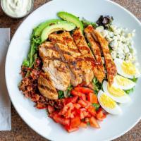 Cobb Salad · Fresh mixed salad greens topped with all natural chicken, Hardwood smoked bacon, tomatoes, f...