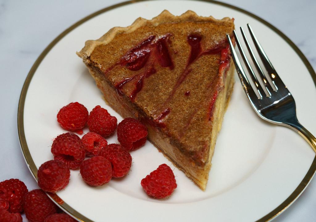 Raspberry Custard Pie · Our raspberry pie is exquisite, reminiscent of the traditional raspberry pie, loaded with a surprising bursting flavors balancing both the sweet and tartness of the raspberry, with equal richness of the butter and sugar, made complete with its flaky crust. It is one of our top picks.