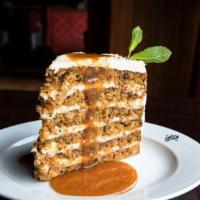 Colossal Carrot Cake  · SPICE CAKE WITH RAISINS, NUTS, PINEAPPLE, AND
CREAM CHEESE FROSTING, CARAMEL SAUCE
Serves 2-4